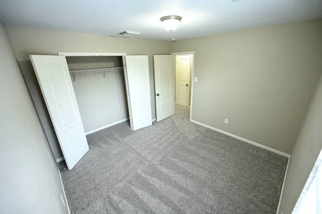 a bedroom with furniture and a wooden floor