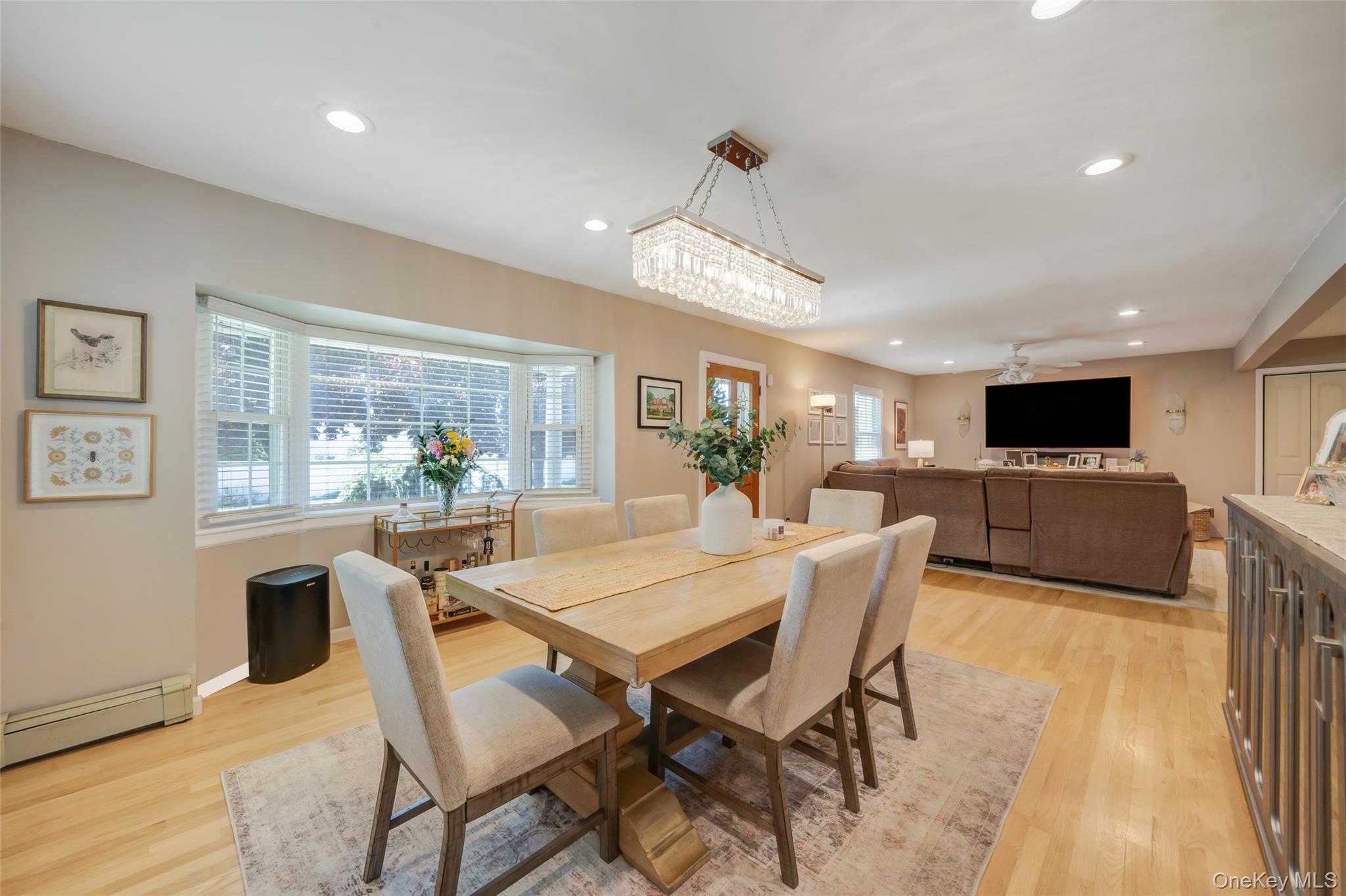 389 Yale Road Franklin Square, NY 11010 - Photo 14 of 43 a view of a dining room with furniture a kitchen and chandelier
