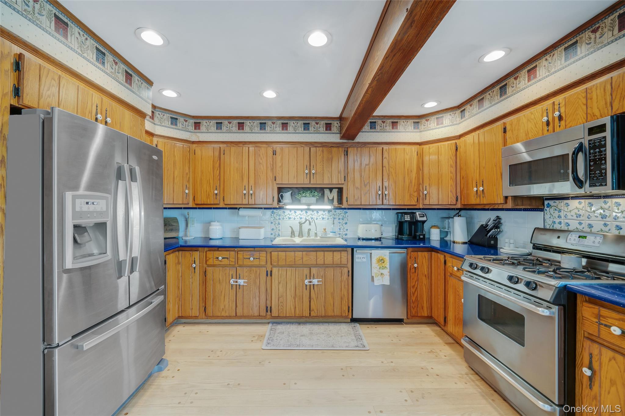 389 Yale Road Franklin Square, NY 11010 - Photo 19 of 43 a kitchen with stainless steel appliances granite countertop a refrigerator a sink dishwasher a stove and white cabinets with wooden floor