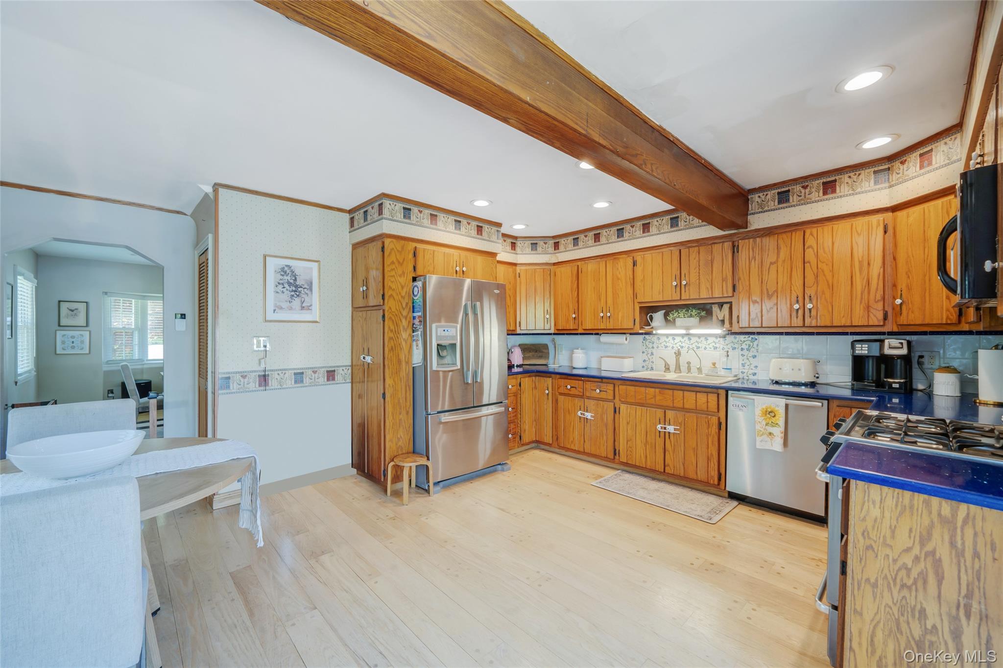 389 Yale Road Franklin Square, NY 11010 - Photo 21 of 43 a large kitchen with stainless steel appliances granite countertop a refrigerator a sink dishwasher a stove and white cabinets with wooden floor