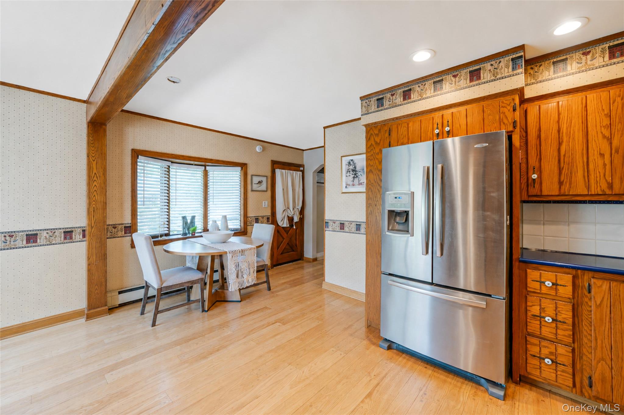 389 Yale Road Franklin Square, NY 11010 - Photo 23 of 43 a kitchen with stainless steel appliances a refrigerator and wooden floor