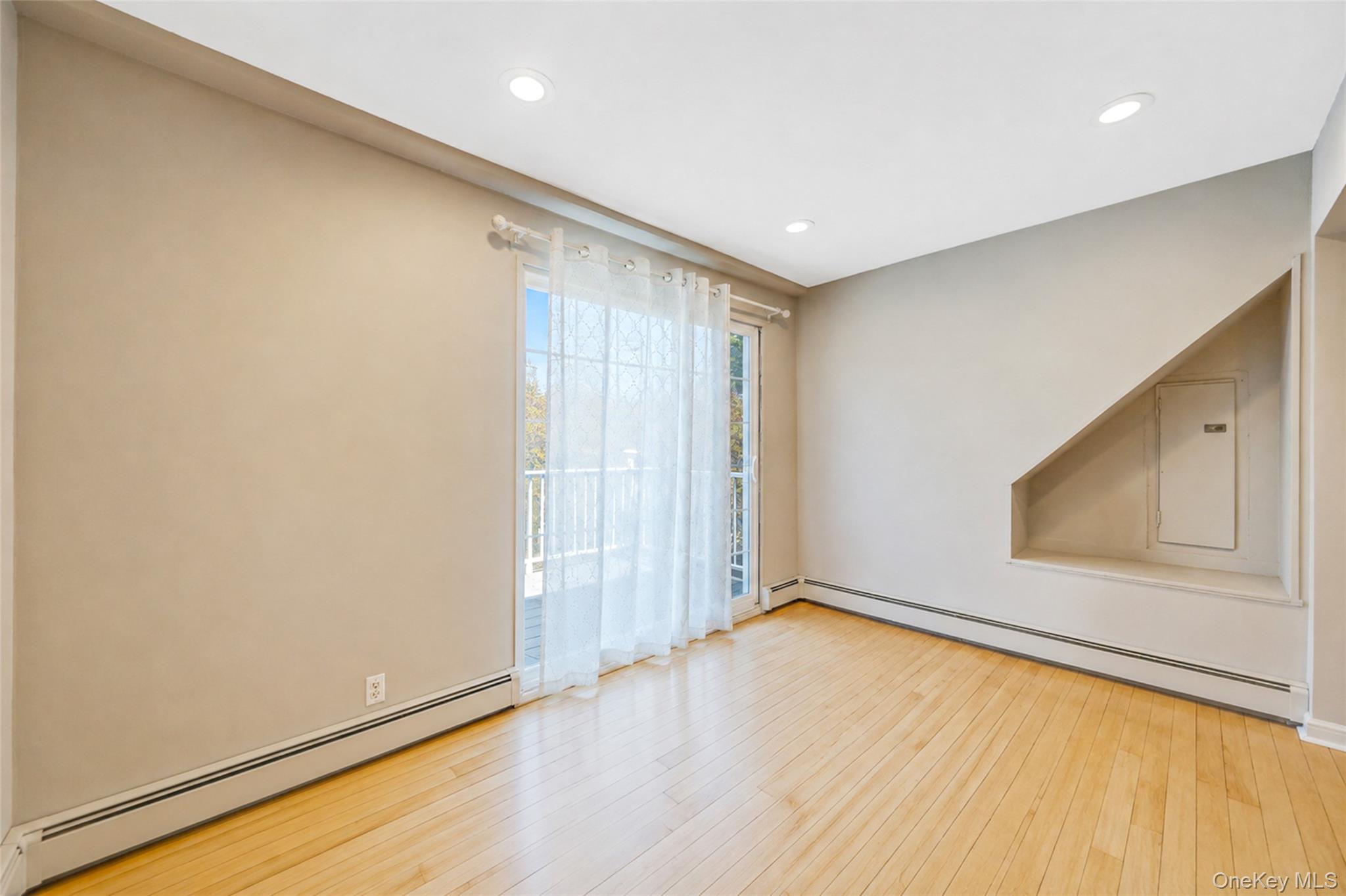 389 Yale Road Franklin Square, NY 11010 - Photo 24 of 43 a view of an empty room with wooden floor and a window