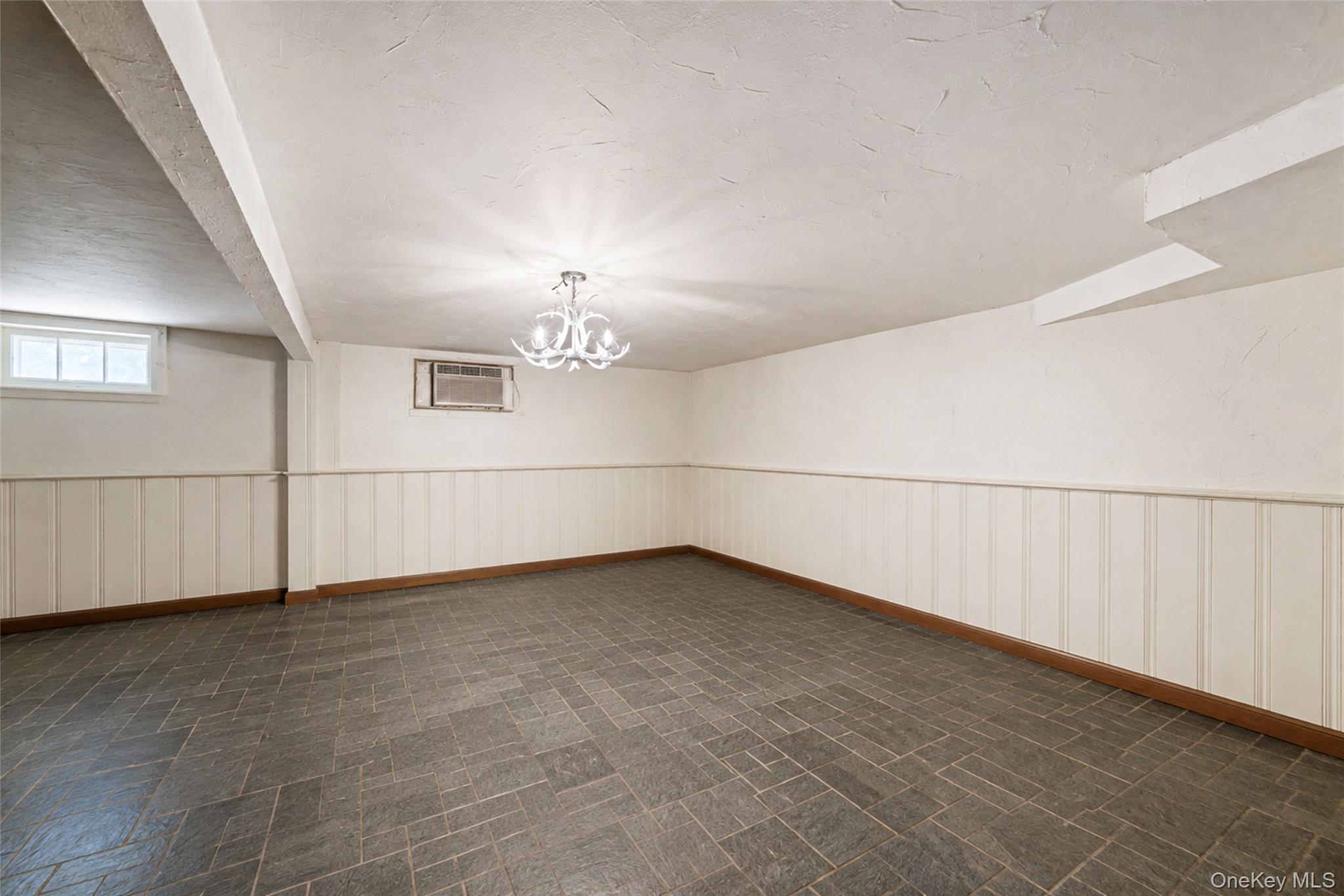 389 Yale Road Franklin Square, NY 11010 - Photo 29 of 43 an empty room with chandelier fan and windows