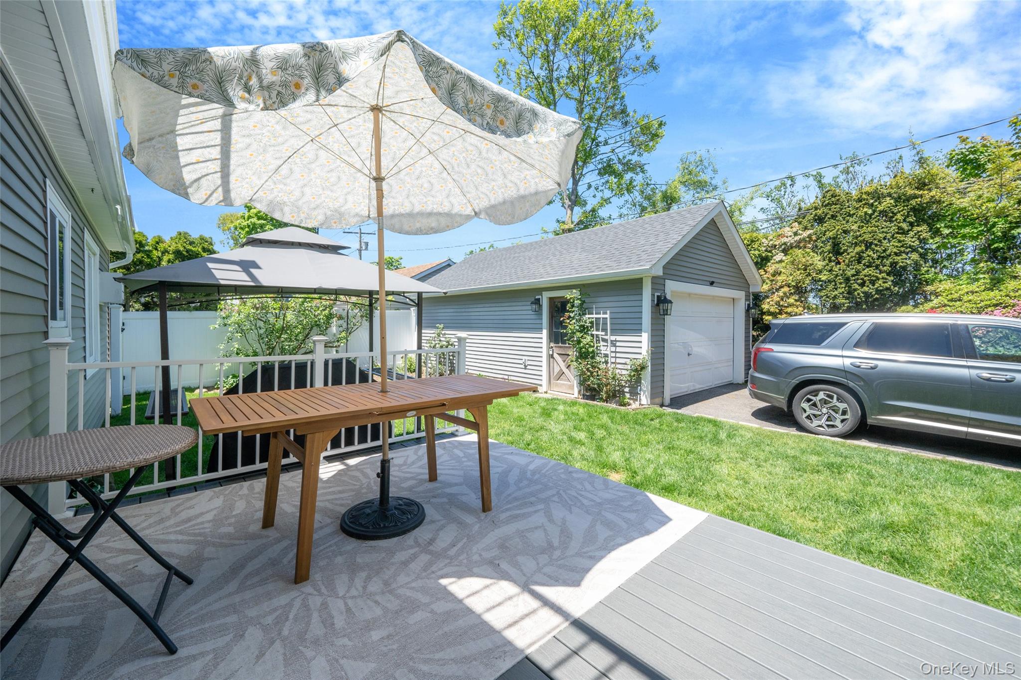 389 Yale Road Franklin Square, NY 11010 - Photo 40 of 43 a view of a patio with table and chairs under an umbrella