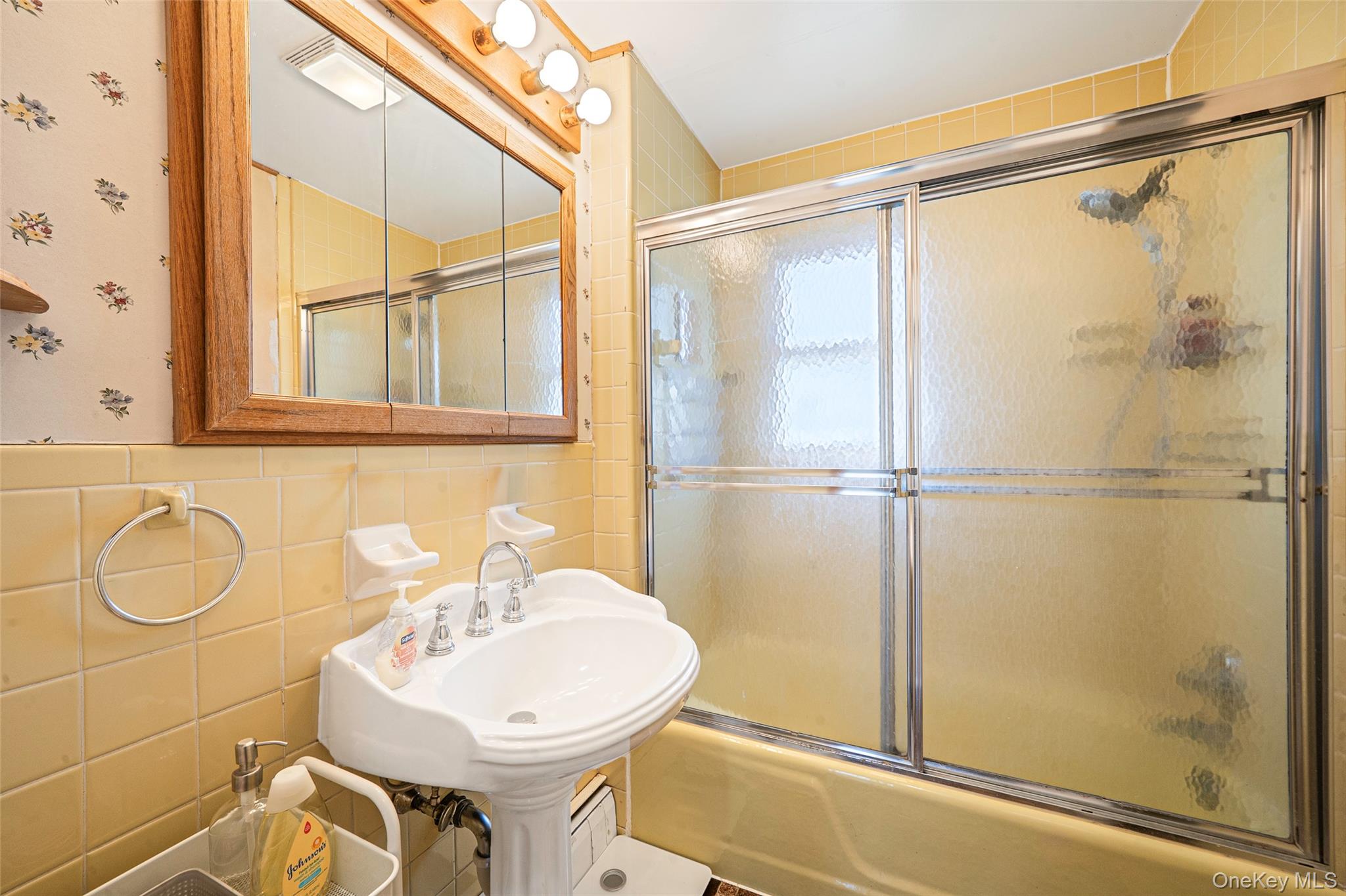 389 Yale Road Franklin Square, NY 11010 - Photo 41 of 43 a bathroom with a sink a mirror a vanity and a shower