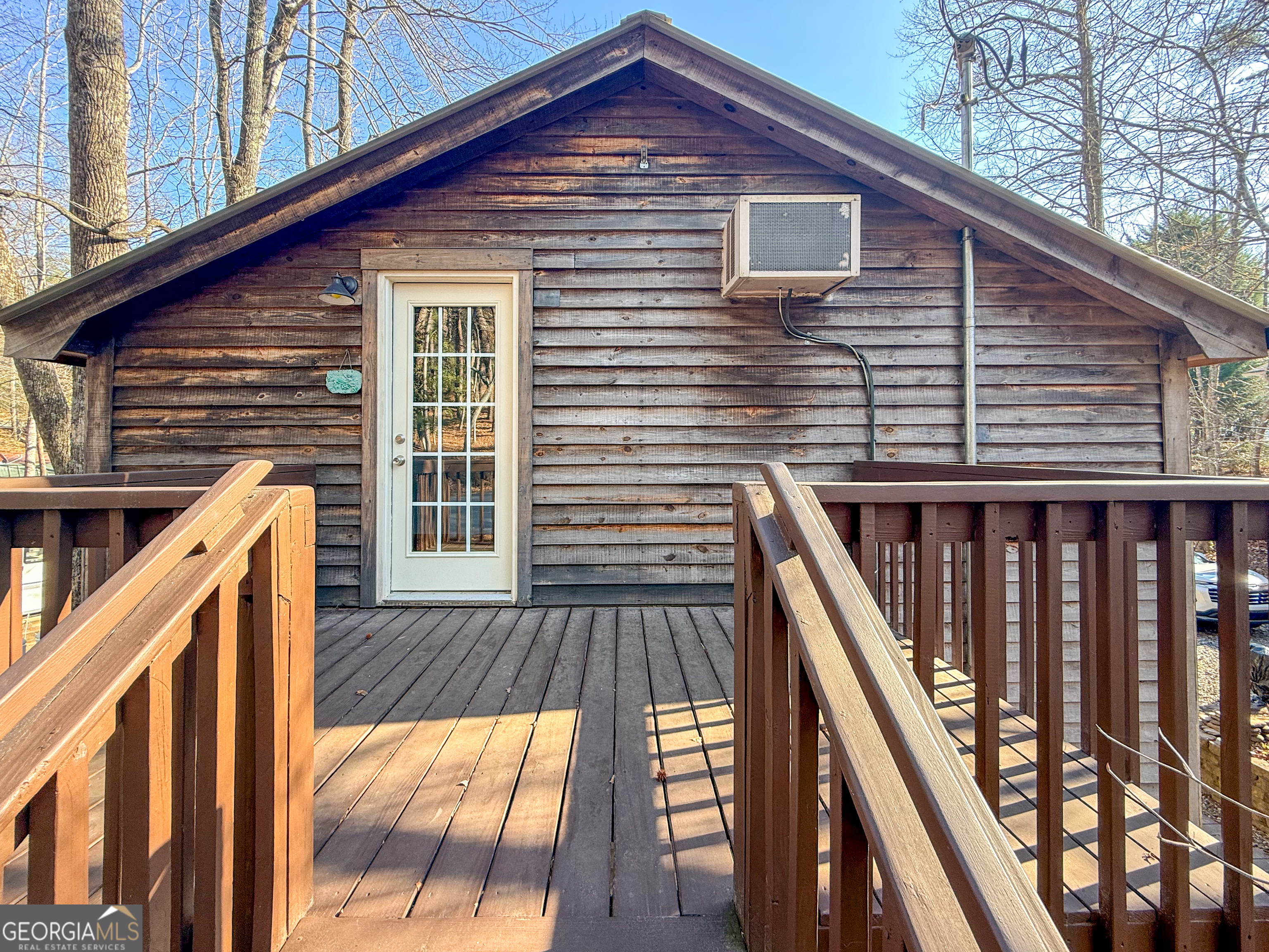 98 Canyon Pass Cleveland, GA 30528 - Photo 29 of 33 a front view of a house with wooden deck and furniture