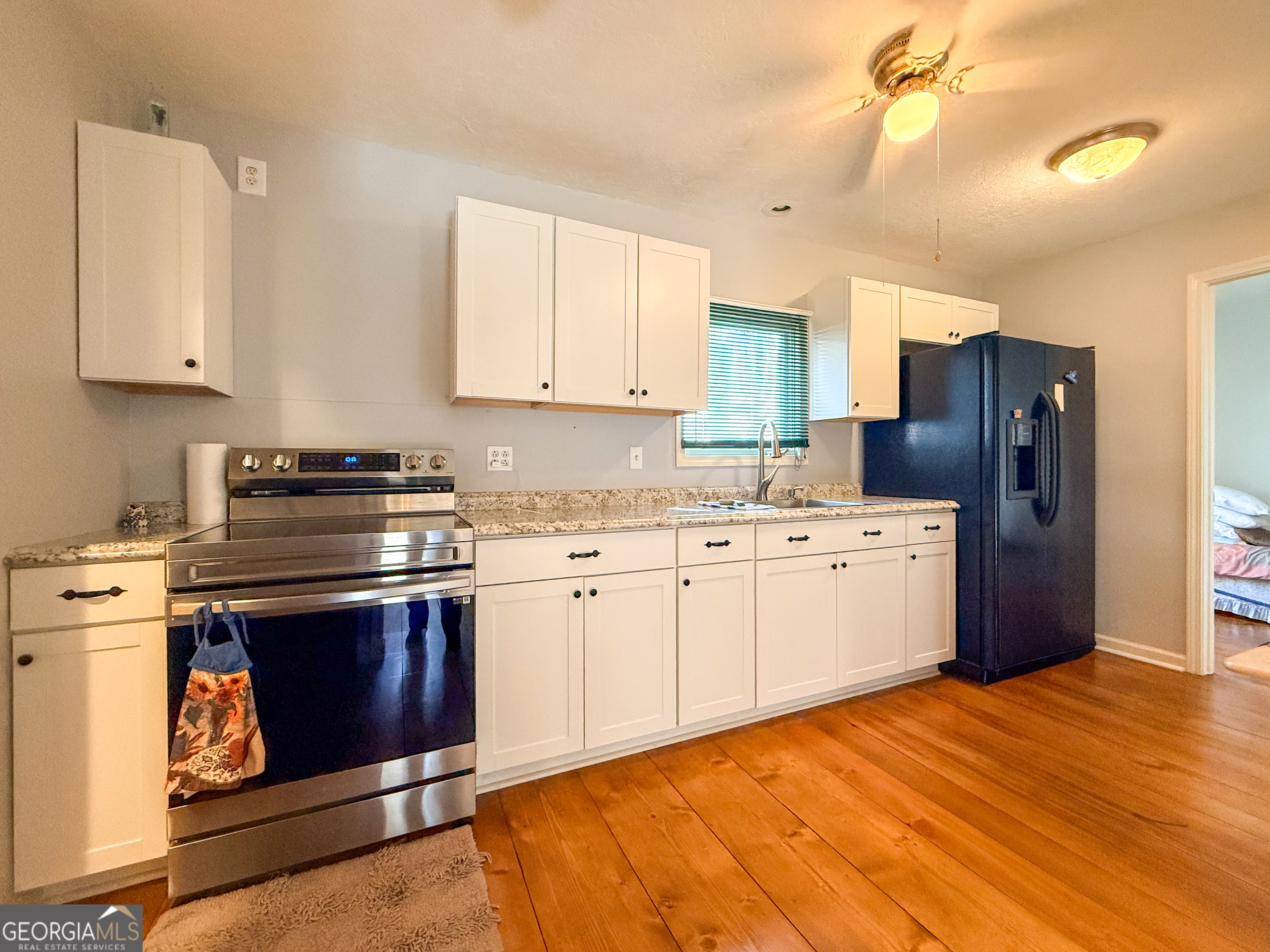 98 Canyon Pass Cleveland, GA 30528 - Photo 9 of 33 a kitchen with stainless steel appliances a stove a refrigerator sink and cabinets