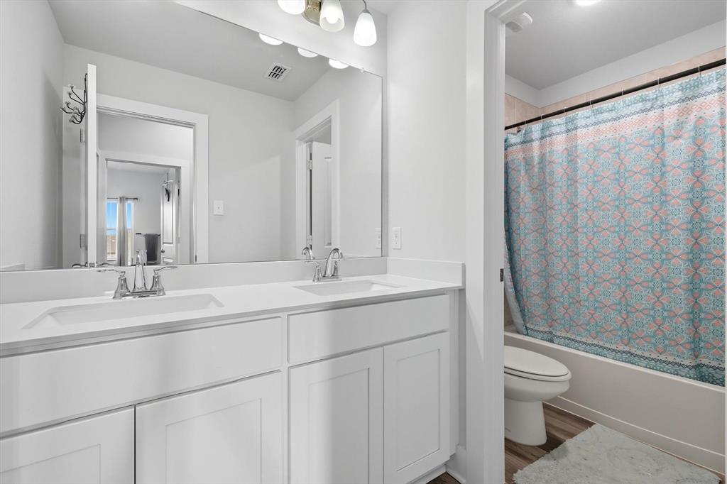2470 Pebble Bank Lane Midlothian, TX 76065 - Photo 16 of 33 a bathroom with a double vanity sink toilet and shower