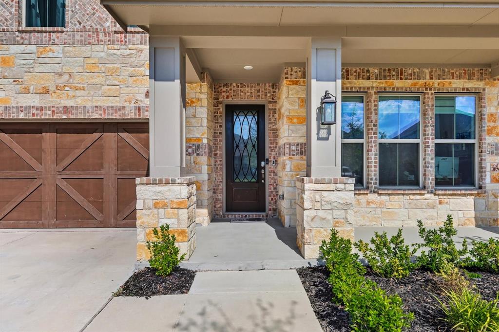 2470 Pebble Bank Lane Midlothian, TX 76065 - Photo 2 of 33 a front view of a building with a garden and plants