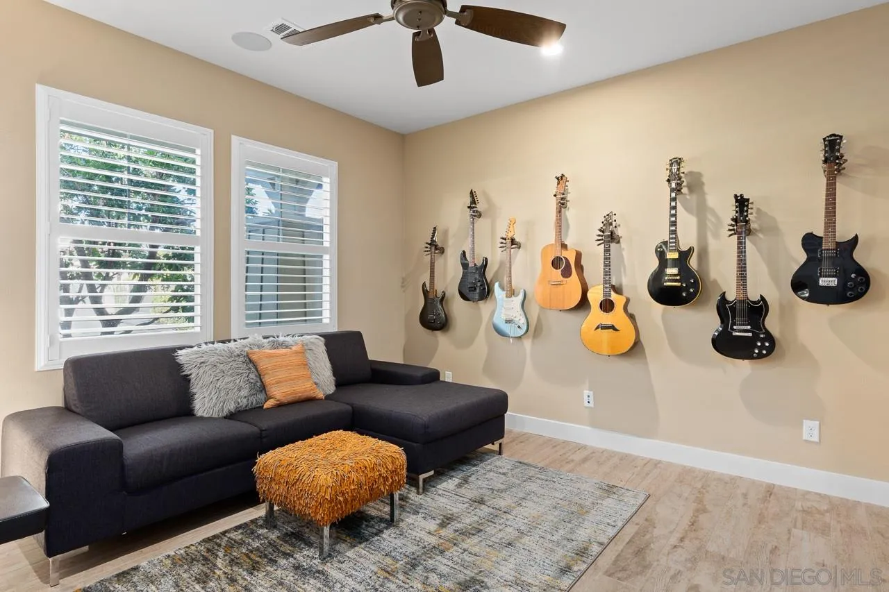 207 Stonesteps Way Encinitas, CA 92024 - Photo 12 of 34 a living room with furniture and a floor to ceiling window
