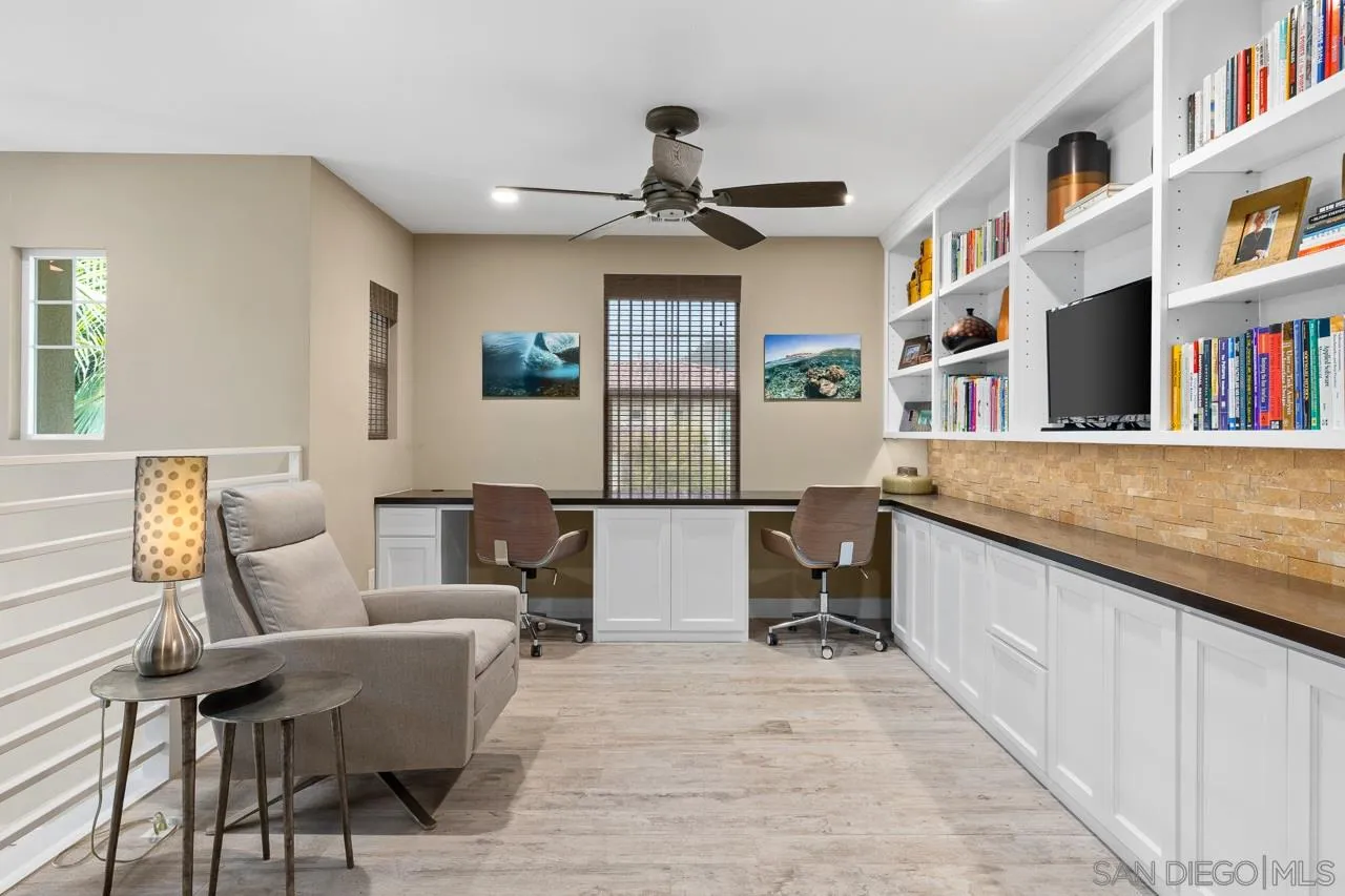 207 Stonesteps Way Encinitas, CA 92024 - Photo 14 of 34 a living room with furniture and a book shelf