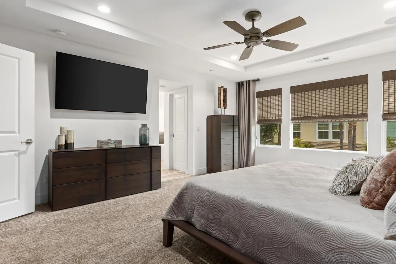 207 Stonesteps Way Encinitas, CA 92024 - Photo 16 of 34 a bedroom with a bed and a flat screen tv