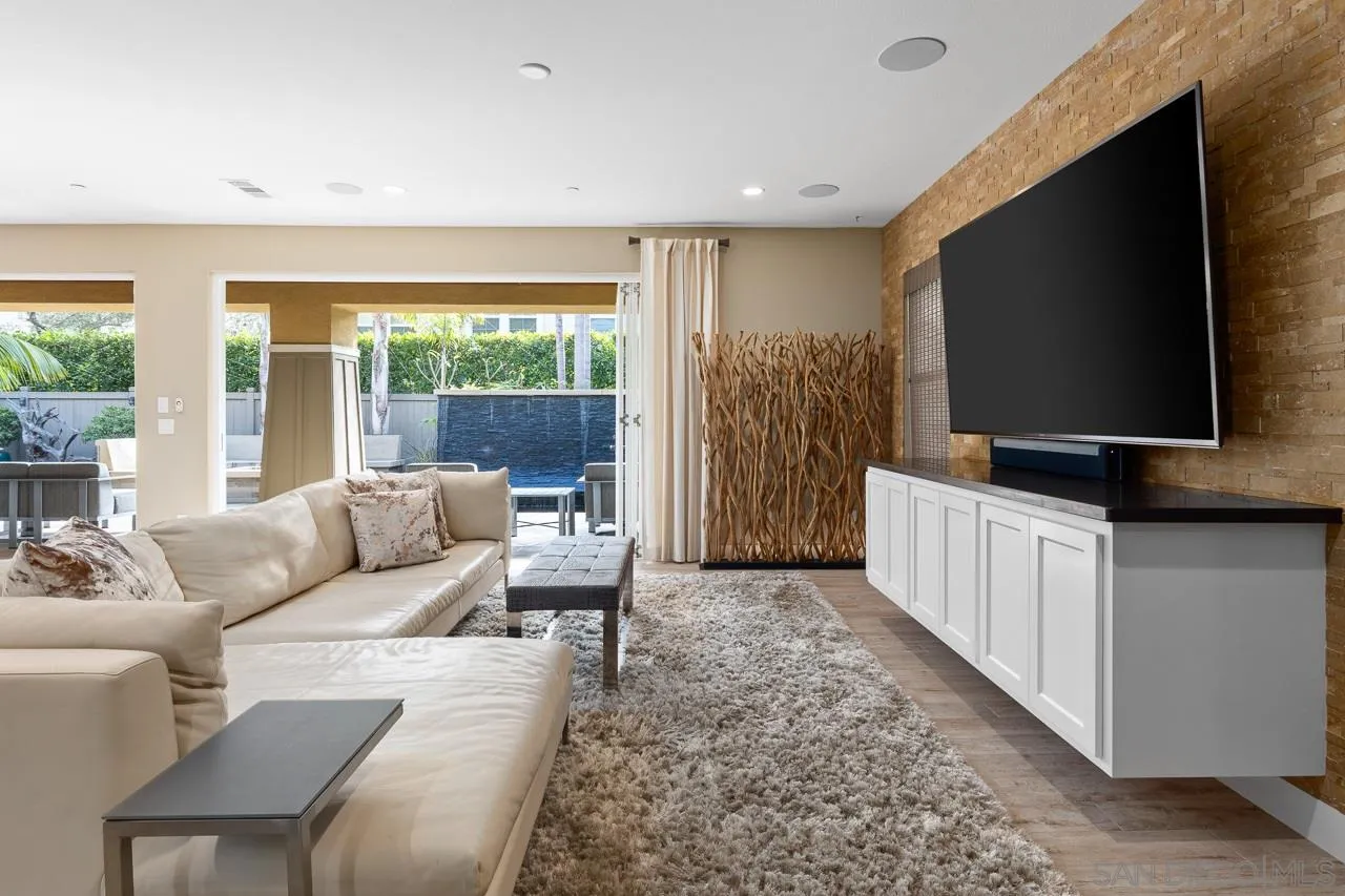 207 Stonesteps Way Encinitas, CA 92024 - Photo 10 of 34 a living room with furniture and a flat screen tv