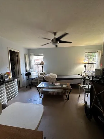 a living room with furniture a window and a flat screen tv