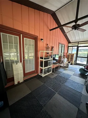 a view of a room with gym equipment and a large window