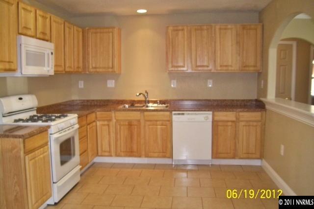 1963 Bishop Street Reno, NV 89512 - Photo 5 of 12 a view of a kitchen with stainless steel appliances granite countertop a stove a sink and a microwave