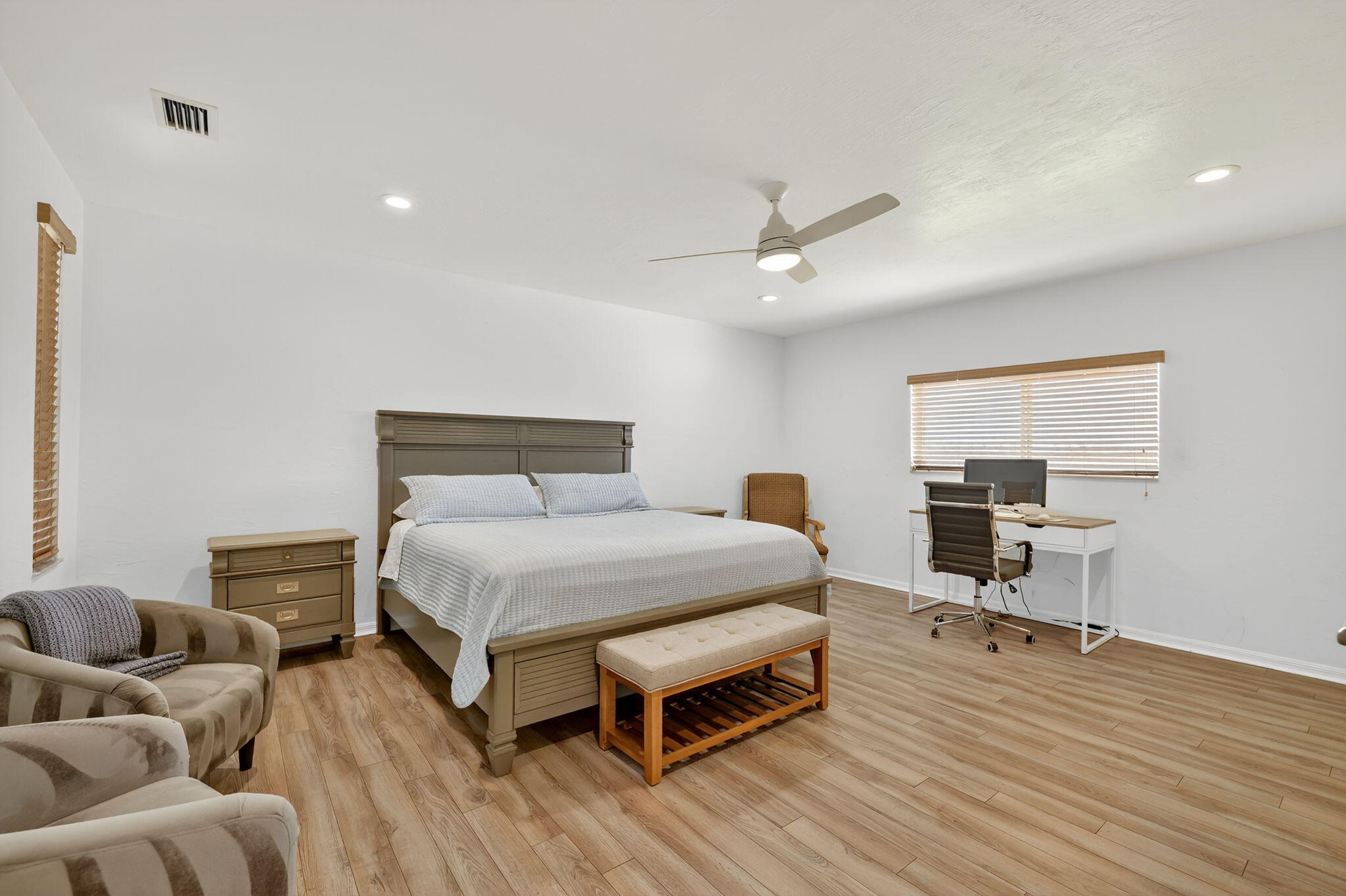 2700 South Header Canal Road Fort Pierce, FL 34945 - Photo 26 of 45 a bedroom with a bed and wooden floor