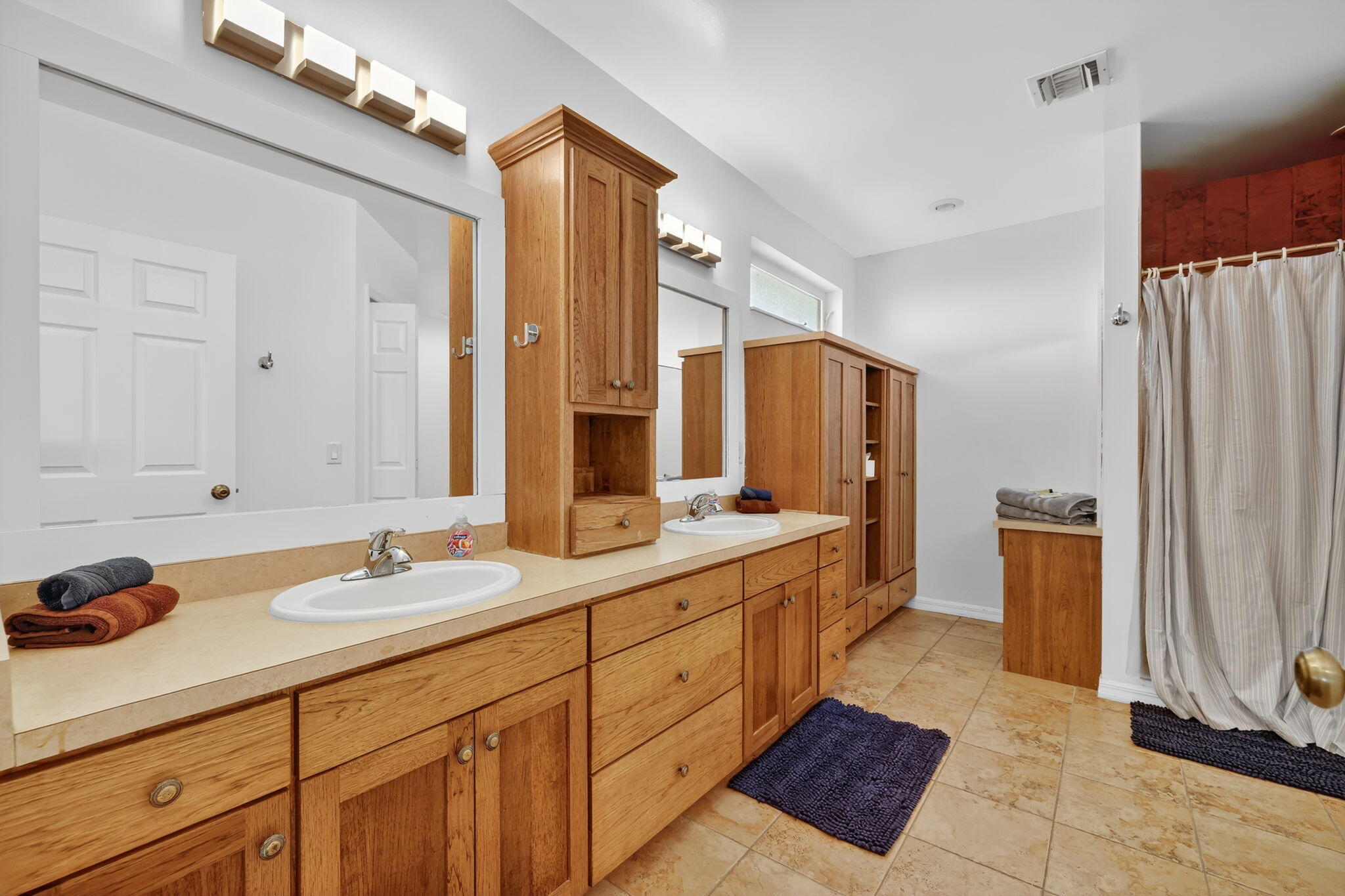 2700 South Header Canal Road Fort Pierce, FL 34945 - Photo 30 of 45 a spacious bathroom with a double vanity sink and a mirror