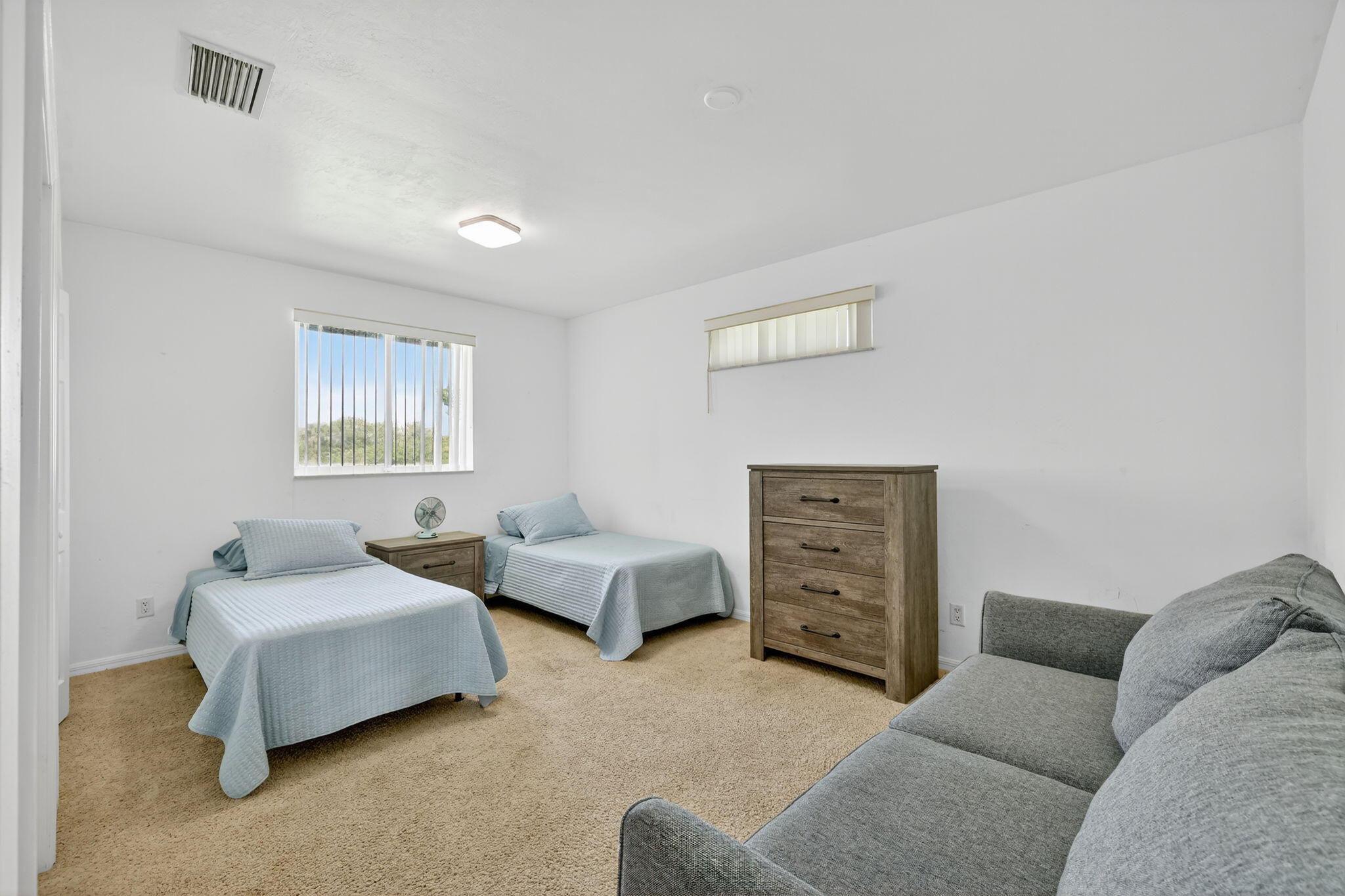 2700 South Header Canal Road Fort Pierce, FL 34945 - Photo 33 of 45 a bedroom with furniture and a couch