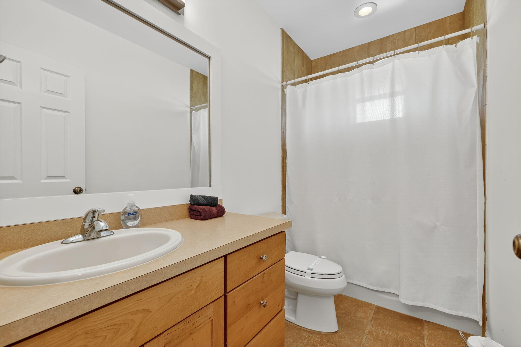 2700 South Header Canal Road Fort Pierce, FL 34945 - Photo 35 of 45 a bathroom with a granite countertop sink a toilet and a large mirror