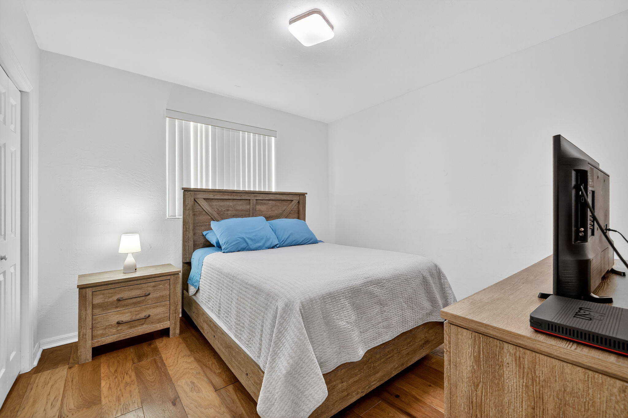 2700 South Header Canal Road Fort Pierce, FL 34945 - Photo 36 of 45 a bedroom with a bed and wooden floor