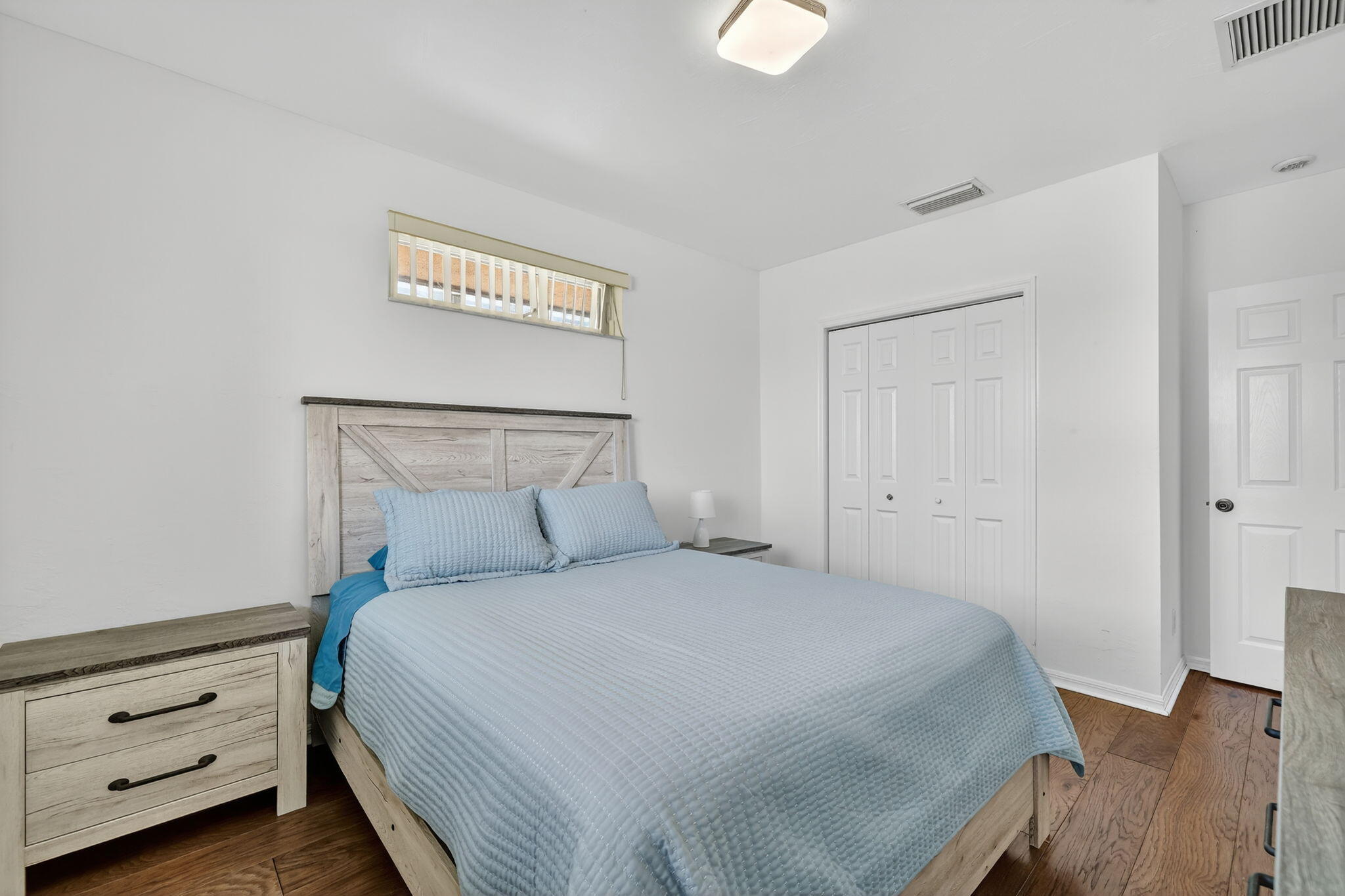 2700 South Header Canal Road Fort Pierce, FL 34945 - Photo 39 of 45 a bedroom with a bed and a night stand