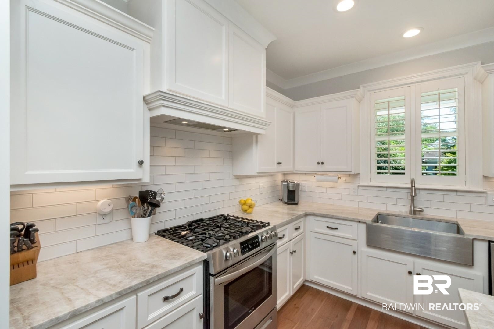 4404 Stein Street Mobile, AL 36608 - Photo 17 of 50 Kitchen with gas range, white cabinetry, light stone counters, tasteful backsplash, and recessed lighting