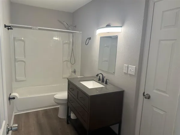 a bathroom with a sink toilet tub and shower