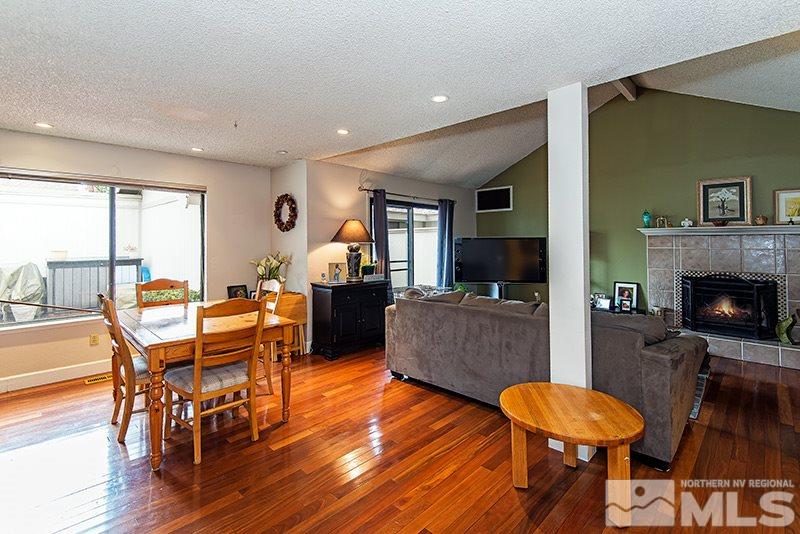 1230 Searchlite Court Reno, NV 89503 - Photo 1 of 1 a living room with furniture a flat screen tv and a fireplace