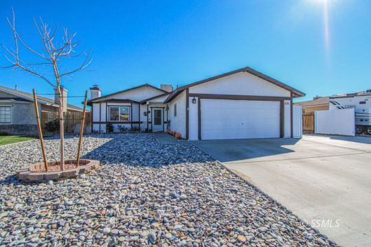 324 Sims Street Ridgecrest, CA 93555 - Photo 1 of 40 a front view of a house with a yard