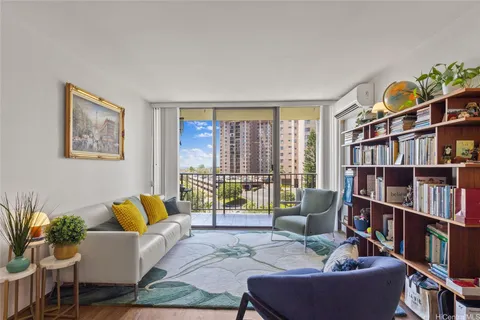 a living room with furniture and a book shelf