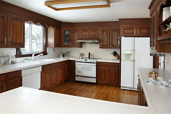 27 Battle Green Road Lexington, MA 02421 - Photo 2 of 7 a kitchen with a sink a stove a refrigerator and cabinets