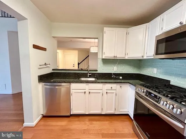 a view of a room with wooden floor