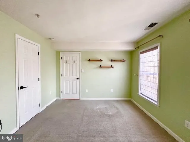 a bedroom with a bed couch and window