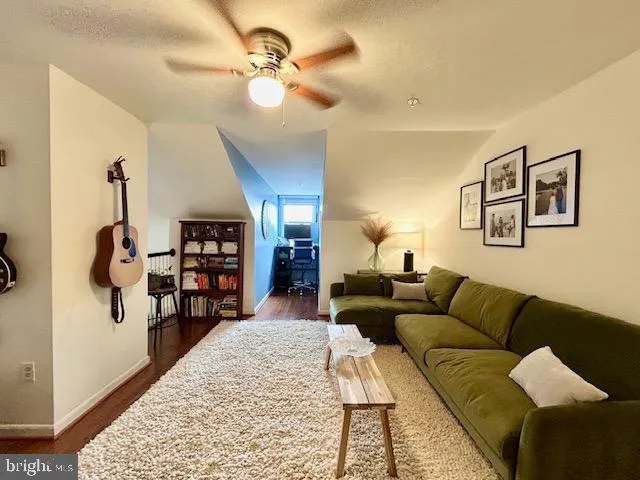 a bedroom with a bed and painting on the wall