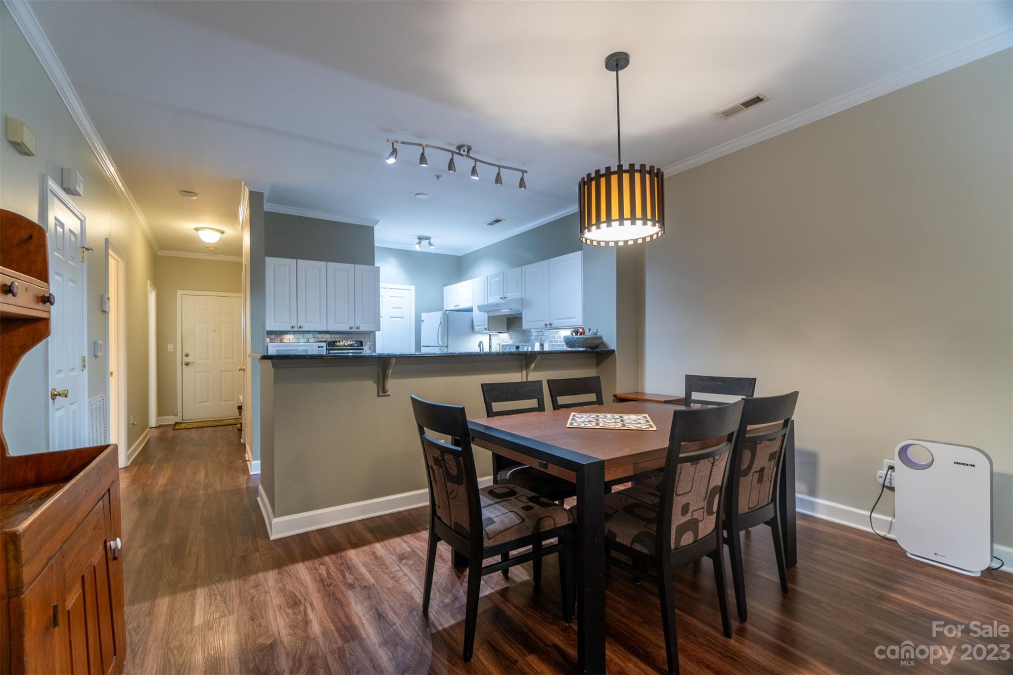 737 Peninsula Drive Davidson, NC 28036 - Photo 6 of 34 a dining room with furniture a chandelier and wooden floor