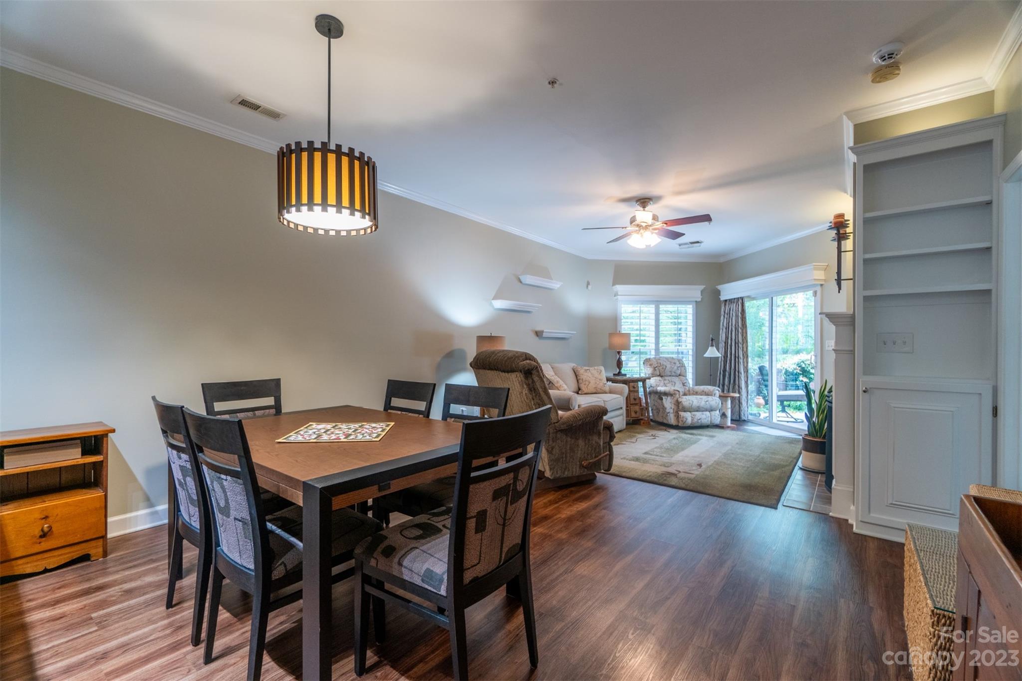 737 Peninsula Drive Davidson, NC 28036 - Photo 7 of 34 a view of a dining room and livingroom with furniture wooden floor a chandelier