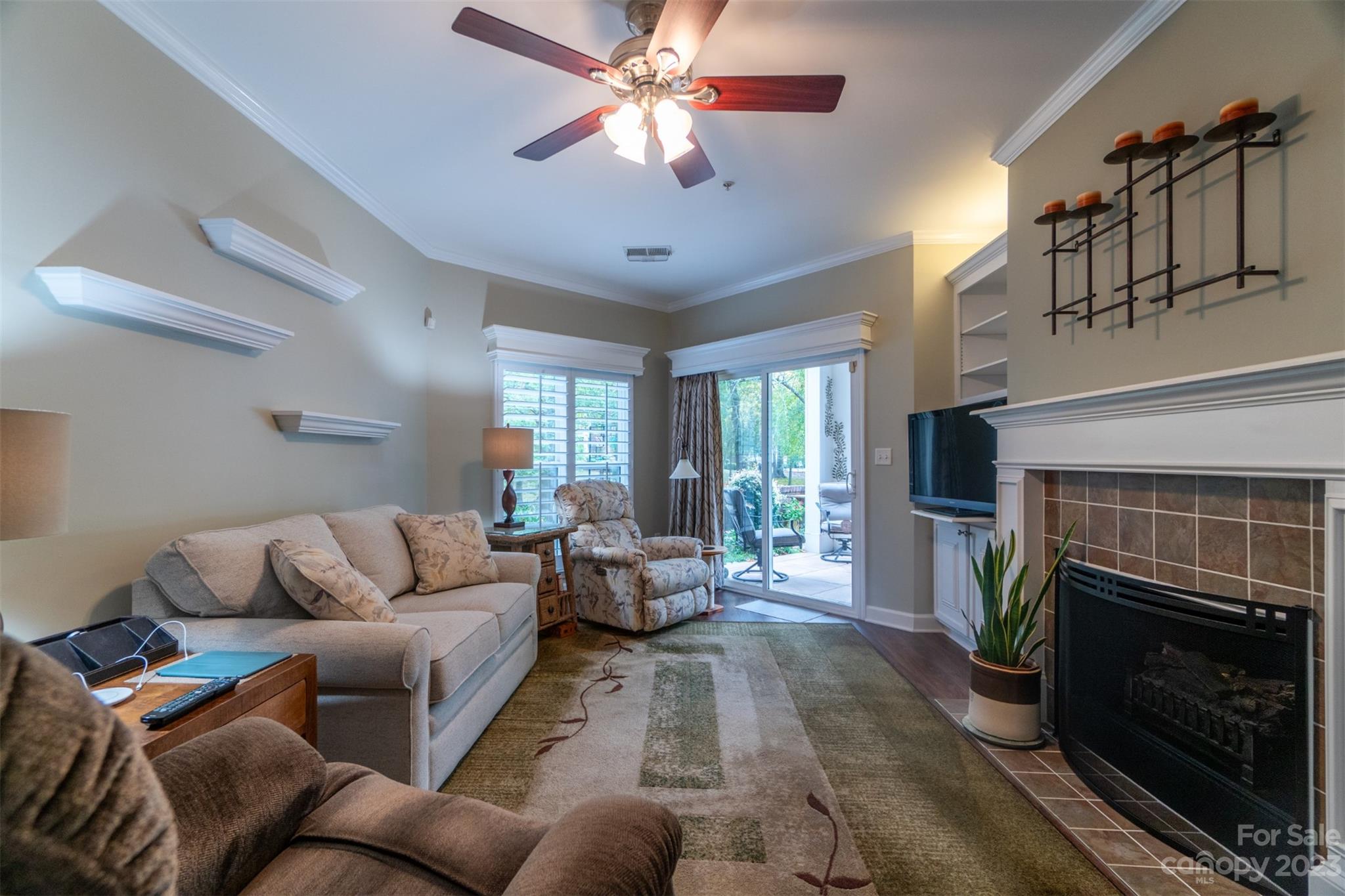 737 Peninsula Drive Davidson, NC 28036 - Photo 10 of 34 a living room with furniture a chandelier and a fireplace