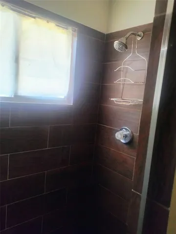 a view of a house with a porch and a yard