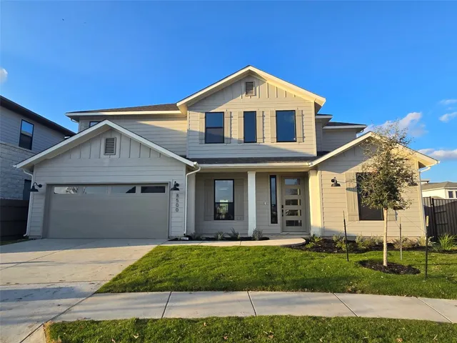 a view of a yard in front view of a house