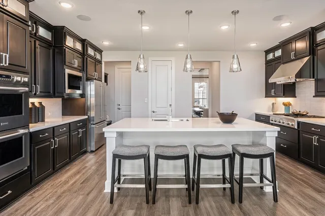a bathroom with a tub shower sink and mirror