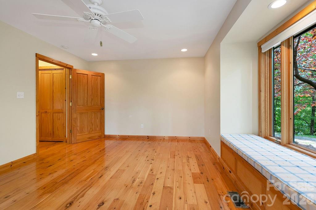 40 Walnut Ridge Road Brevard, NC 28712 - Photo 28 of 47 a view of an empty room with wooden floor and a window