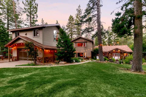 a front view of a house with a yard porch and outdoor seating