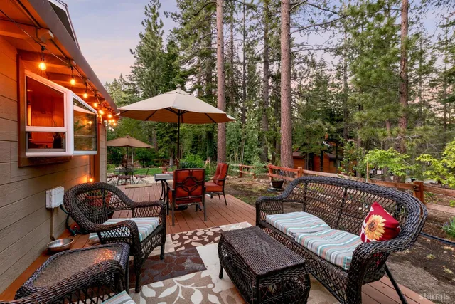 a view of a patio with table and chairs under an umbrella