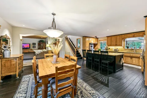 a living room with dining room and wooden floor