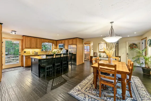 a kitchen with stainless steel appliances granite countertop a sink stove and wooden cabinets
