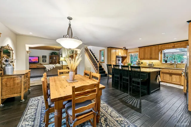 a kitchen with kitchen island granite countertop wooden cabinets a sink and stainless steel appliances