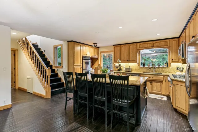 a kitchen with stainless steel appliances granite countertop a stove and a sink
