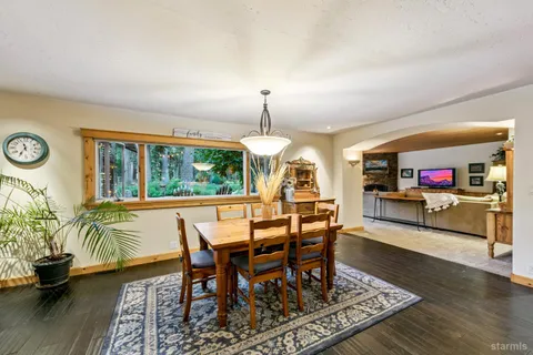 a view of a dining room with furniture window and wooden floor
