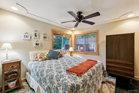a bedroom with a large bed and a chandelier